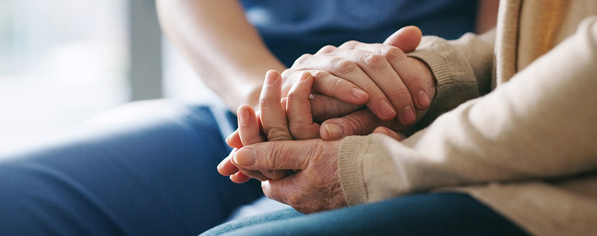 Caregiver holding hands