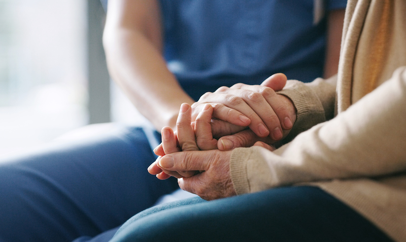 Caregiver holding hands
